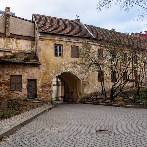 A beautiful shot of an old building with metal gates in Autumn
